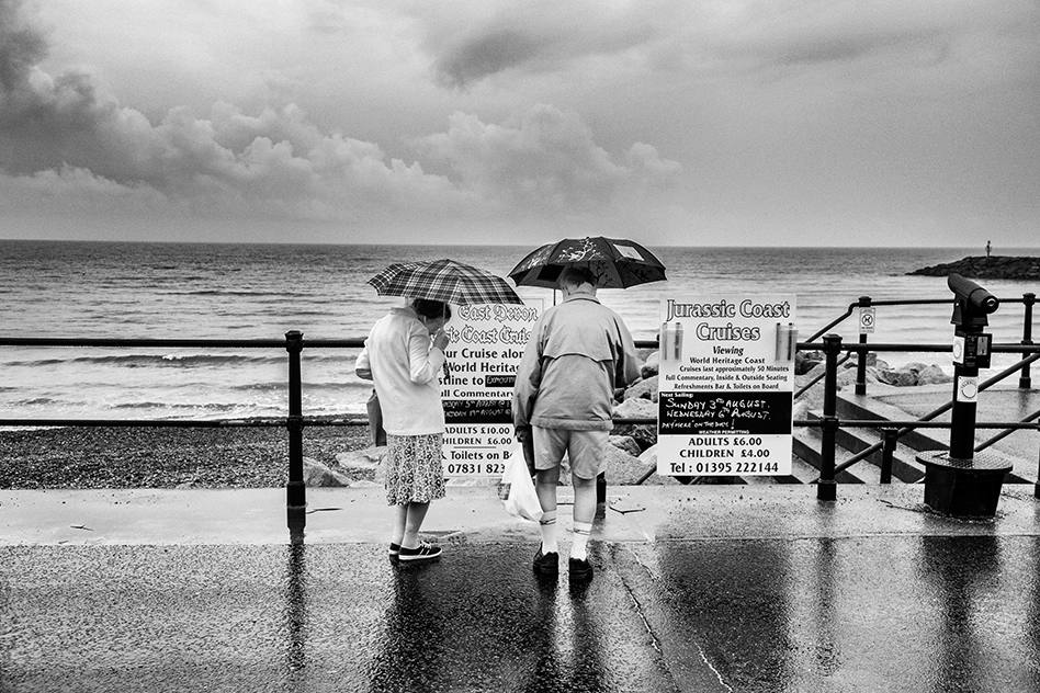 Sidmouth, Devon. People with umbrellas